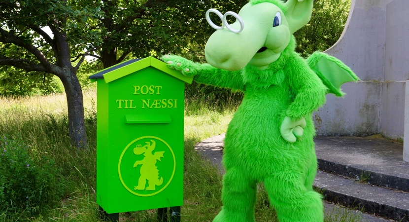 Næstved grønne maskot Næssi står foran sin kæmpe grønne postkasse ved vandtårnet på Åsen